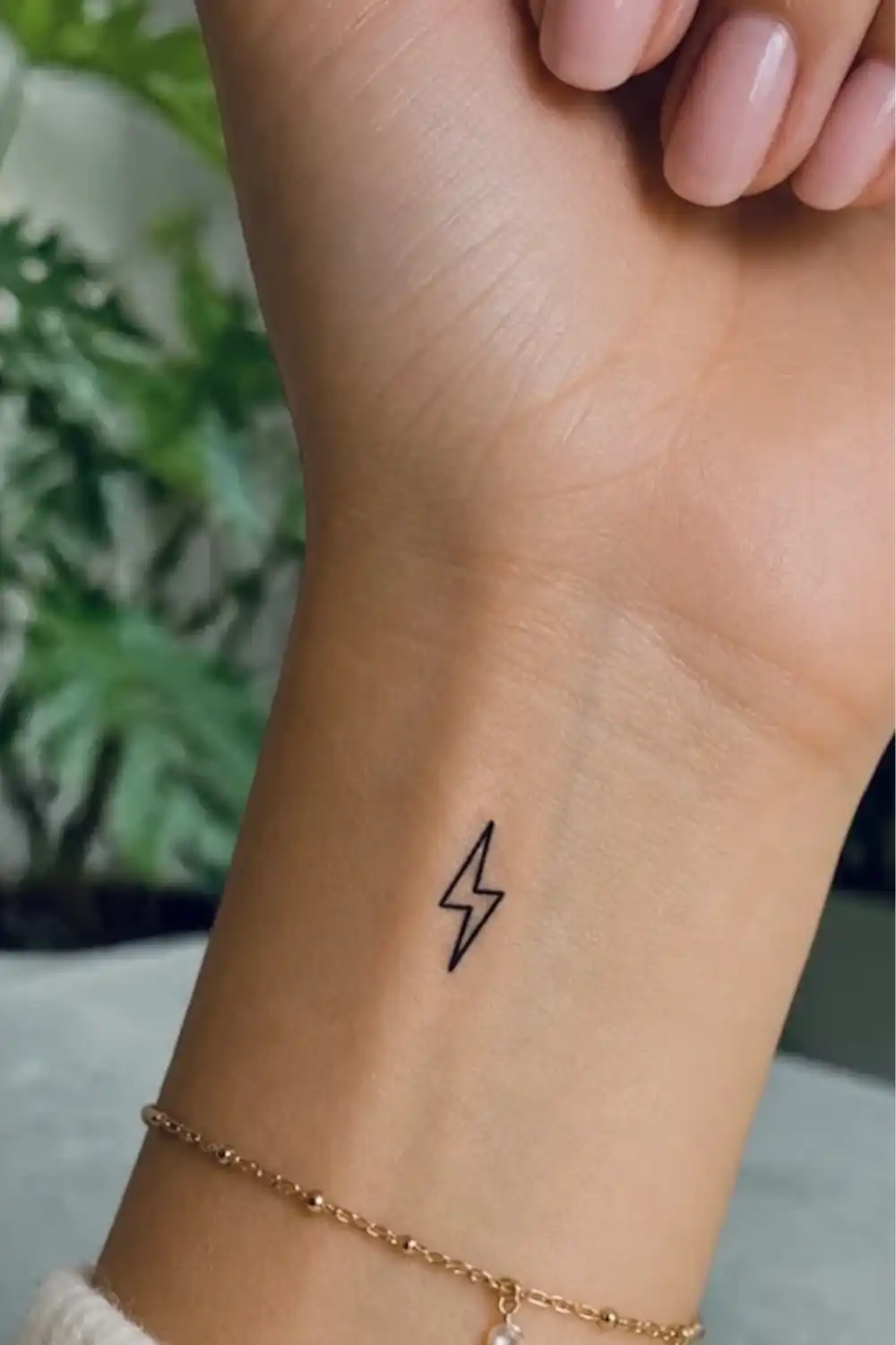 EasyTatt review photo of a small minimalist lightning bolt temporary tattoo applied to a woman's wrist